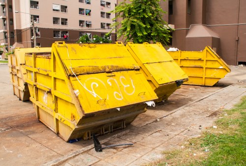 Workers handling commercial waste with safety gear